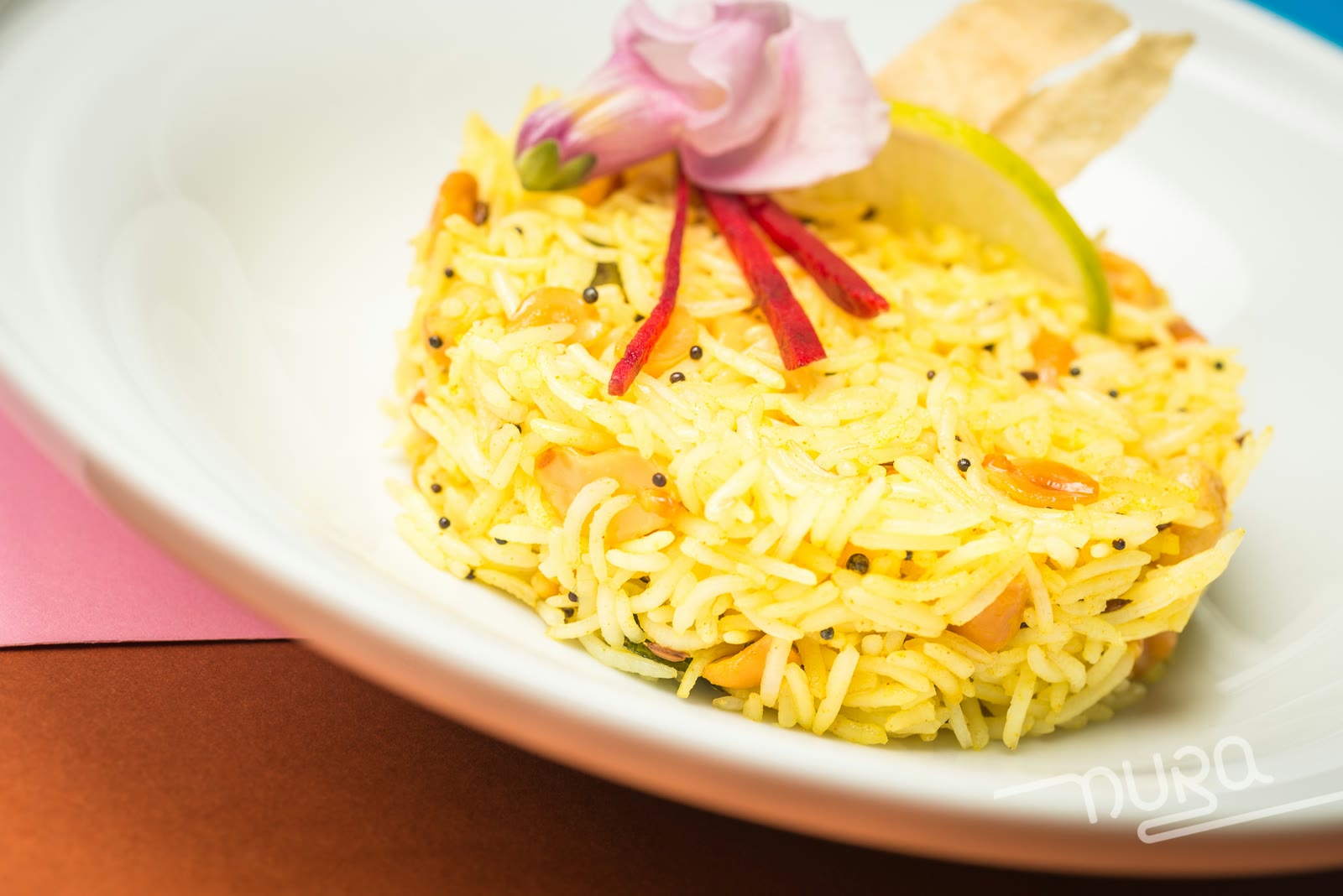 Lemon rice with mustard seeds and beetroot on a white plate
